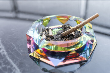 Colorful Ashtray With Cannabis Joints On Marble Surface