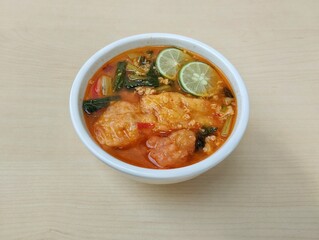 Seblak is a spicy culinary dish from Indonesia containing crackers vegetables and spices, Top view	