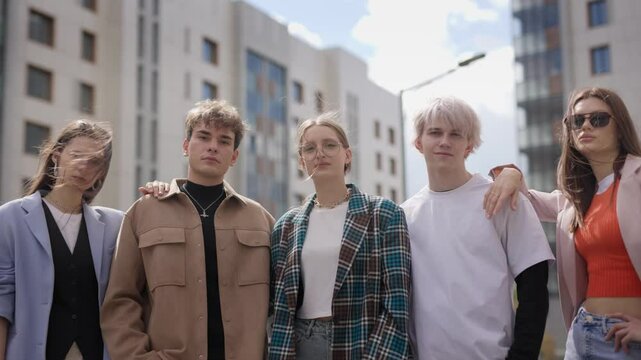 Stylish young friends from diverse youth subcultures posing and enjoying time together in city center