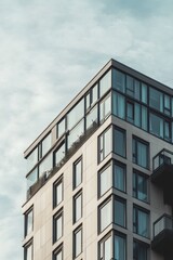 Modern Urban Building with Glass Balcony and Cloudy Sky Background