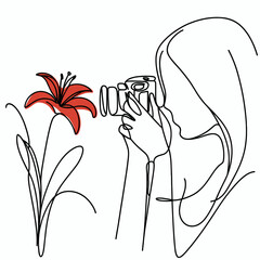 Woman photographing flower 
