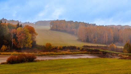 Vibrant autumn landscape with colorful foliage and rolling hills in a serene countryside setting