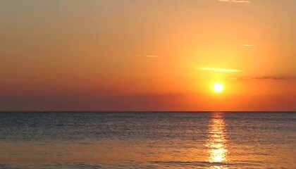 Obraz premium Golden Sunset Over Calm Ocean.
