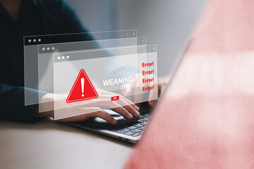 Businessman using laptop with spam virus with warning for internet security alert and data breach...