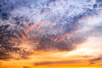 Obraz premium Sky,Beautiful sunset view, luxury soft gradient orange gold clouds and sunlight on the blue dramatic sky perfect for the background, morning, evening,Twilight, climate change,horizontal sunset photo