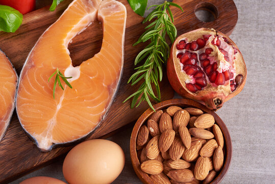 Delicious portion of fresh salmon fillet with aromatic herbs, spices and vegetables - healthy food, diet or cooking concept. Balanced nutrition concept for clean eating flexitarian mediterranean diet.
