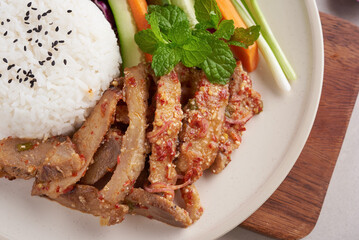 Rice with grilled pork neck. Grilled pork salad thai food with herbs and spices ingredients, tradition northeast food delicious with fresh vegetables, Hot and spicy slice grilled pork menu asian food.