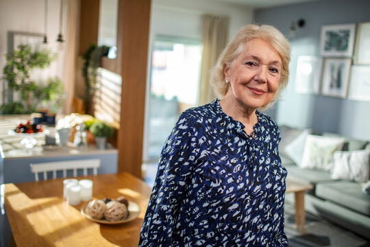 Happy senior woman smiling confidently at home