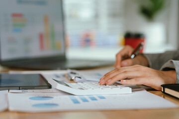 Businessman analyzing financial charts and documents at office desk, focused on planning, investment, accounting, growth strategy, and corporate success