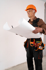 Senior retired architect builder holding plan of rooms. civil engineer working with documents. building and home renovation
