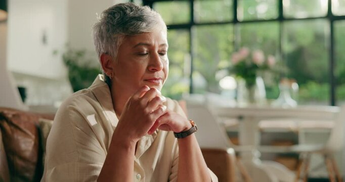 Thinking, sad and mature woman in home with depression, unsure and reflection in living room. Mental health, retirement and senior person with thoughtful, memory and wondering for wellness in house