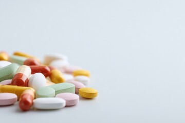 close-up of modern pills and tablets scattered across clean surface emphasizing minimalistic design