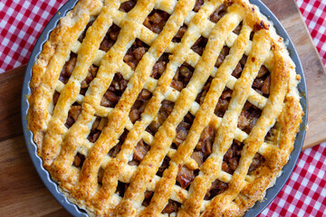 pie apple homemade in tray on tablecloth red-white scotch pattern