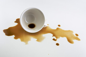 The spilled coffee from the sloppy glass is on the white floor.