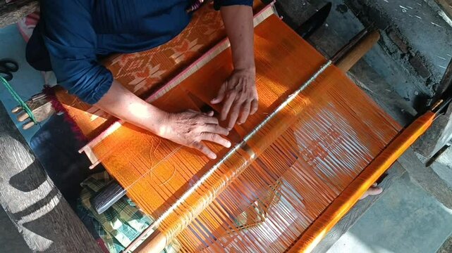 The process of making traditional handwoven fabric from Lombok, Indonesia, is done manually without using machines, employing tools made of wood.

