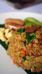 Javanese Fried Rice Delight: Authentic Javanese fried rice topped with sunny-side-up egg & savory sliced sausage. Perfect for Indonesian cuisine, comfort food, and street food visuals