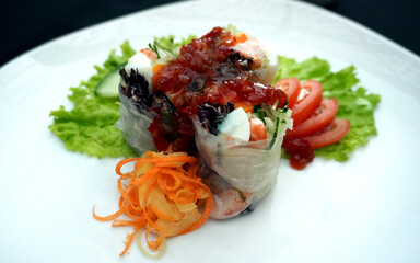See the goodness! Crisp veggies inside delicate, clear spring rolls. A delicious and light choice.