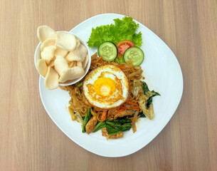 Delicious fried noodles with crisp fresh vegetables, tender shredded chicken, and a perfectly fried egg. A savory, satisfying meal!