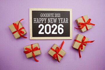 Happy New Year 2026 typography text with gift box on purple background