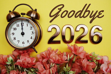 Goodbye 2026 text with alarmclock and flower decoration on yellow background