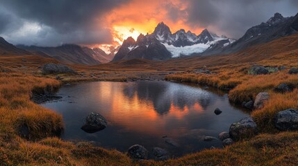 Fiery Sunset Over Mountain Peaks Reflected in Still Pond