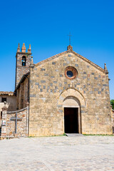Fototapeta premium Historic Romanesque church in Monteriggioni, Tuscany, under a clear blue sky
