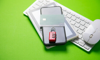 Padlock and credit card on the green background.