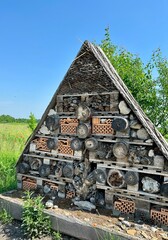 A handmade structure made of natural materials, created as a shelter for insects - includes wooden...
