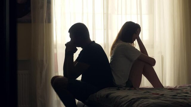 A couple sits together in silence, emotionally distant and disconnected. Despite physical closeness, tension and isolation dominate. A visual concept of relationship crisis and mental health.
