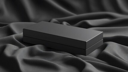 Sleek black rectangular box on dark fabric