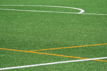 Obraz premium Green artificial turf field ready for play during sunny afternoon hours