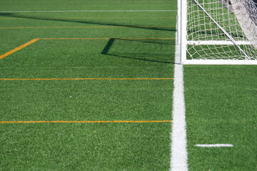 Green turf field with soccer goal ready for an exciting match ahead