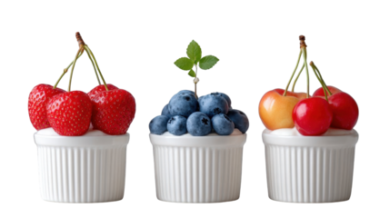 Fresh strawberries, blueberries, and cherries in white ramekins with mint leaf, vibrant colors