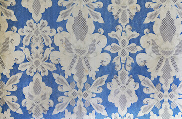 Old wallpaper on the wall. Old wallpaper for texture or background.