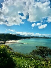The beautiful vast ocean and sandy shoreline of Lanikai Beach on the island of O'ahu, Hawai'i on a sun-soaked day in summer. 