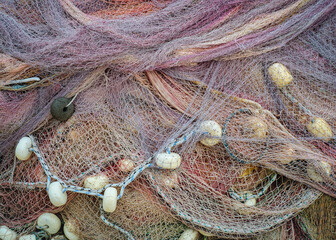 Pile of fisher nets, abstract pattern for design or decor element of fishery produce or catch equipment. Neap of fishing nets for your texture background, close-up view.