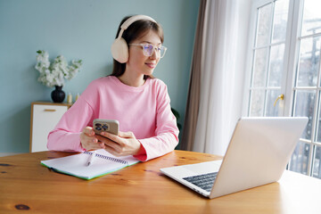 Engaging in an Online Learning Session at Home in a Cozy, Well-Lit Room While Listening to Music...