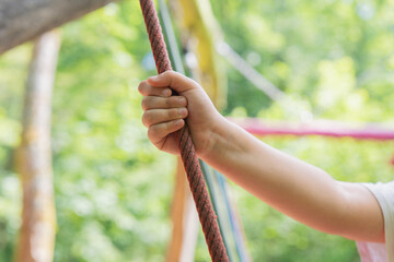 Enjoying the thrill of adventure while climbing in a vibrant outdoor playground