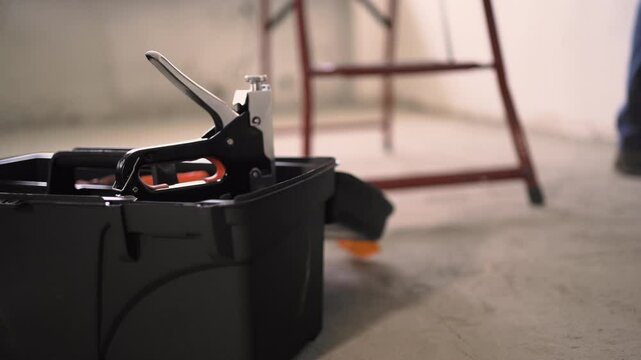 repairman taking a stapler from the toolbox