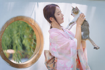Pretty young Asian Japanese woman in Traditional Yukata Dress. A young Asian girl is wearing a...