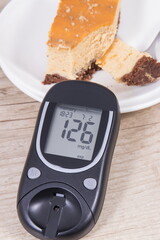 Glucometer and portion of cheesecake. Measuring and checking sugar level during diabetes