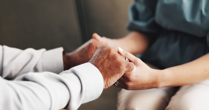 Therapy, holding hands and mature patient for consulting, comfort and support with grief at clinic. People, psychologist and counselling for mental health, anxiety and kindness with care on sofa