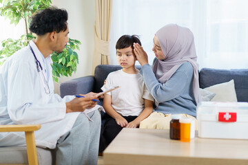 Asian muslim woman take her son the see a doctor in hospital.