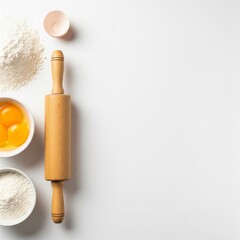 Baking concept with flour, eggs, and a rolling pin arranged as a border, a flat lay with ample copy space for a recipe

