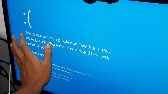 Handheld footage of a computer monitor displaying a blue screen, recorded using a smartphone without stabilizer