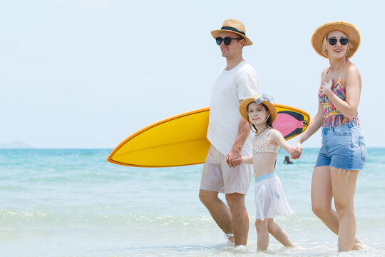 Caucasian family including father, mother, and daughter are delightful enjoy with beach vacation activities. - Powered by Adobe