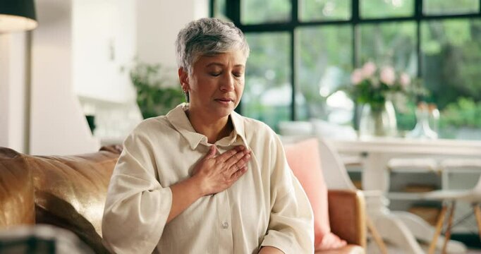 Mature woman, cough and chest pain on sofa with massage, stress and tired breathing in living room. Person, sore throat and bronchitis with lung disease, flu and sick with fatigue on couch at house