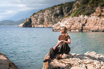 Female digital nomad working remotely from a cozy place in nature Remote work, sustainability,...