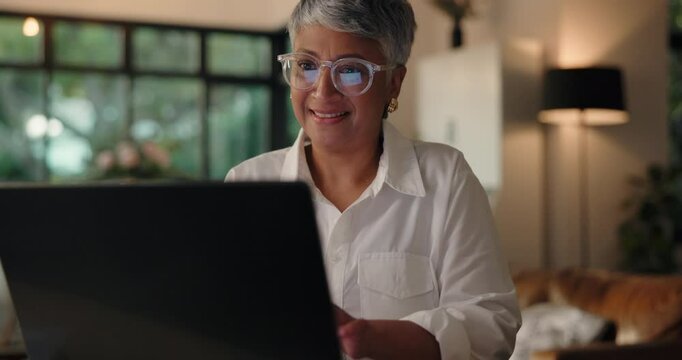 Laptop, freelancer and mature woman in home office for editing report and news. Computer, hybrid work and happy person online with positive review, journalism and editor in chief reading article