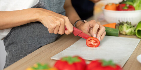 Couple Cooking Together. Joyful moment of a couple preparing fresh vegetables in a modern kitchen.